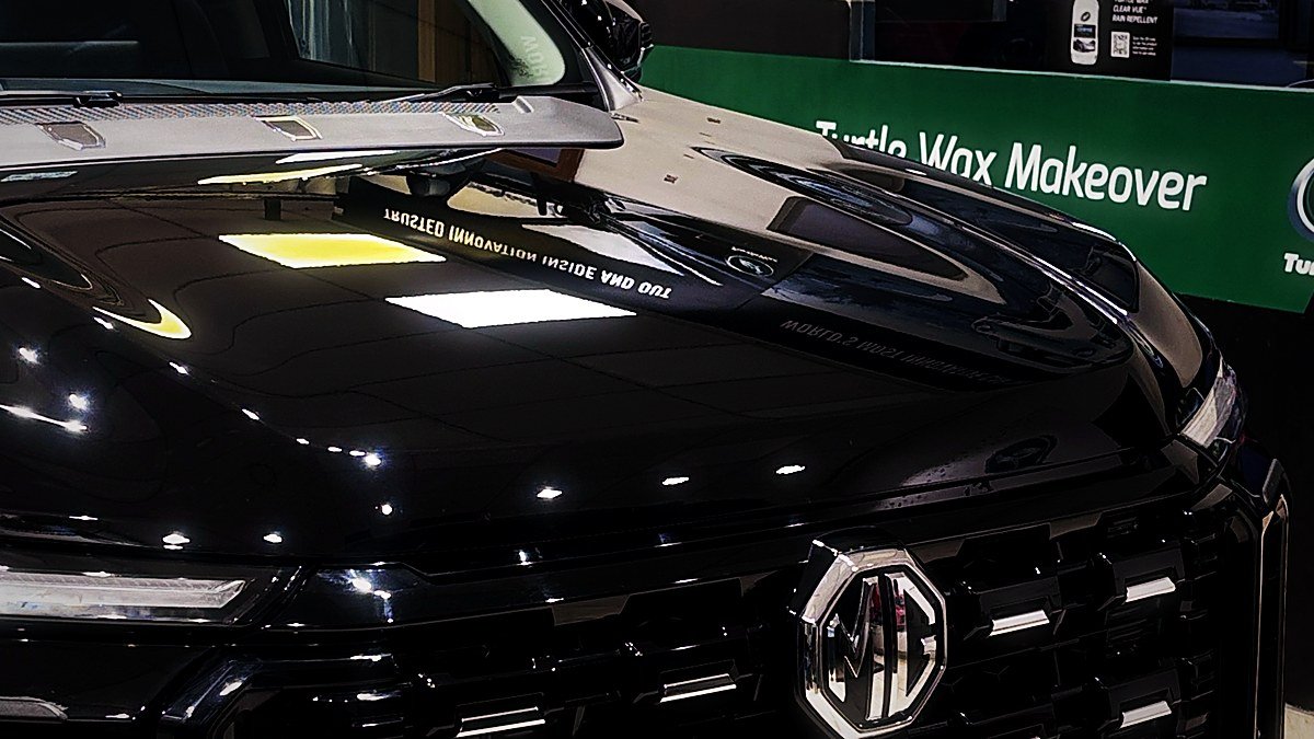 A black MG being detailed under the Turtle Wax Makeover banner at the Tellapur studio