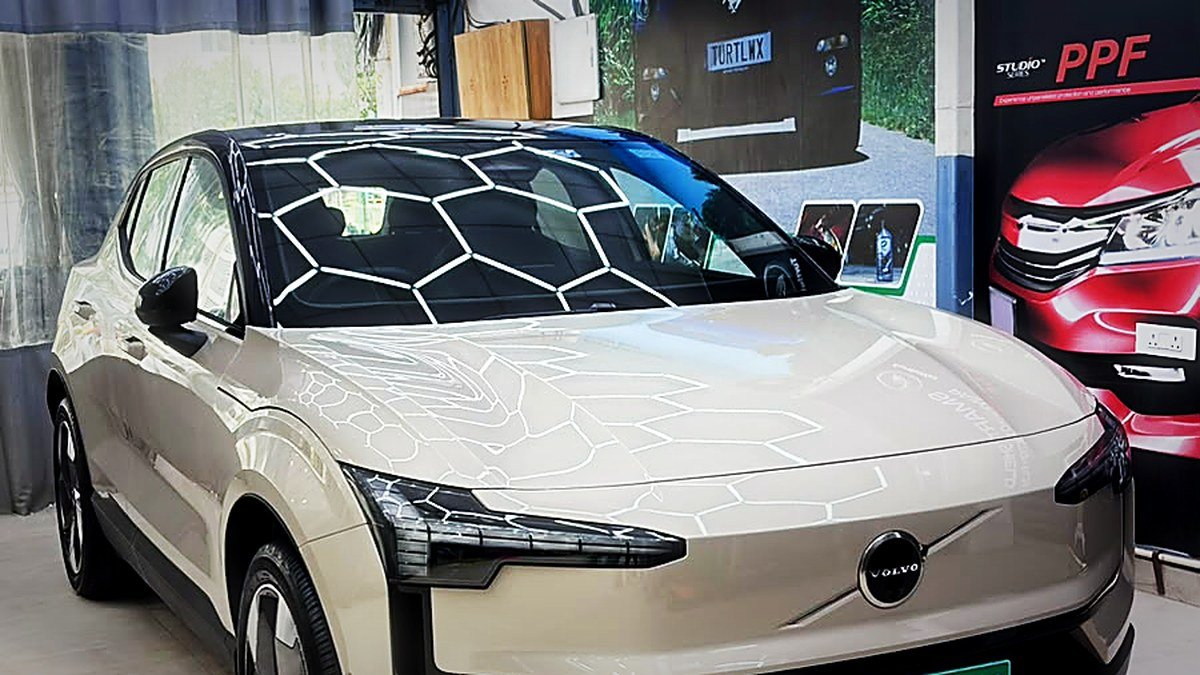 A Volvo EX30 with green EV plates at Turtle Wax Studio Tellapur