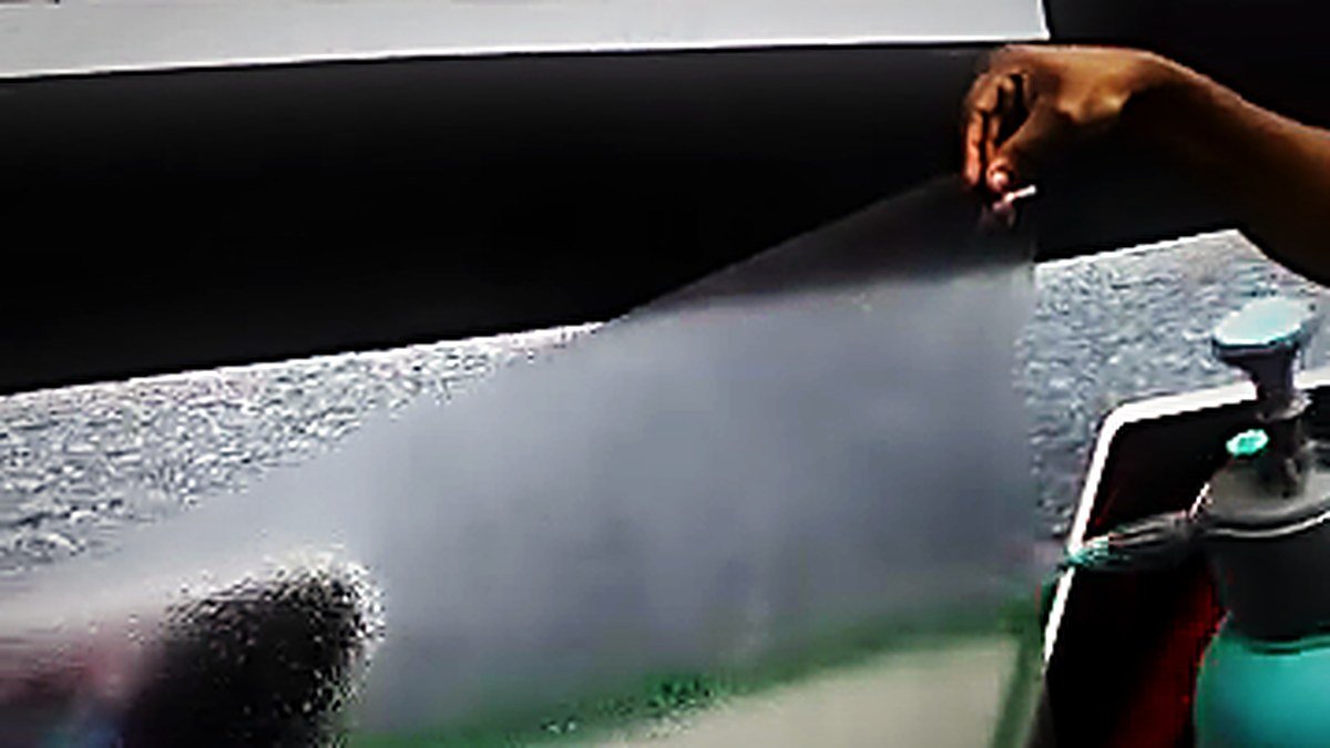 Paint protection film being fitted to a panel at Turtle Wax Studio Tellapur
