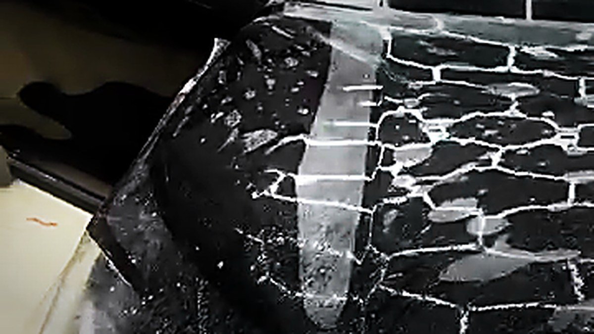 Paint protection film being laid over a black bonnet at Turtle Wax Studio Tellapur