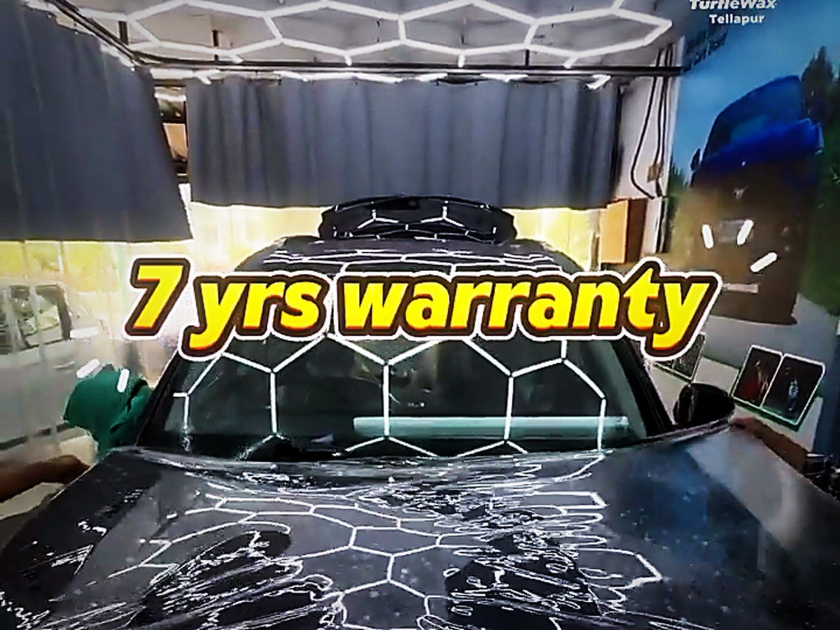 Paint protection film being fitted to a black Mahindra XUV700 bonnet at Turtle Wax Studio Tellapur