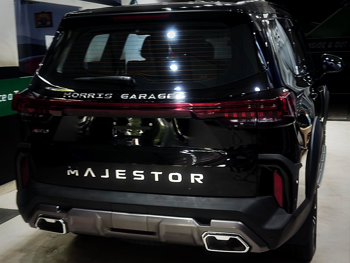 The rear of a black MG Majestor with tinted glass inside Turtle Wax Studio Tellapur