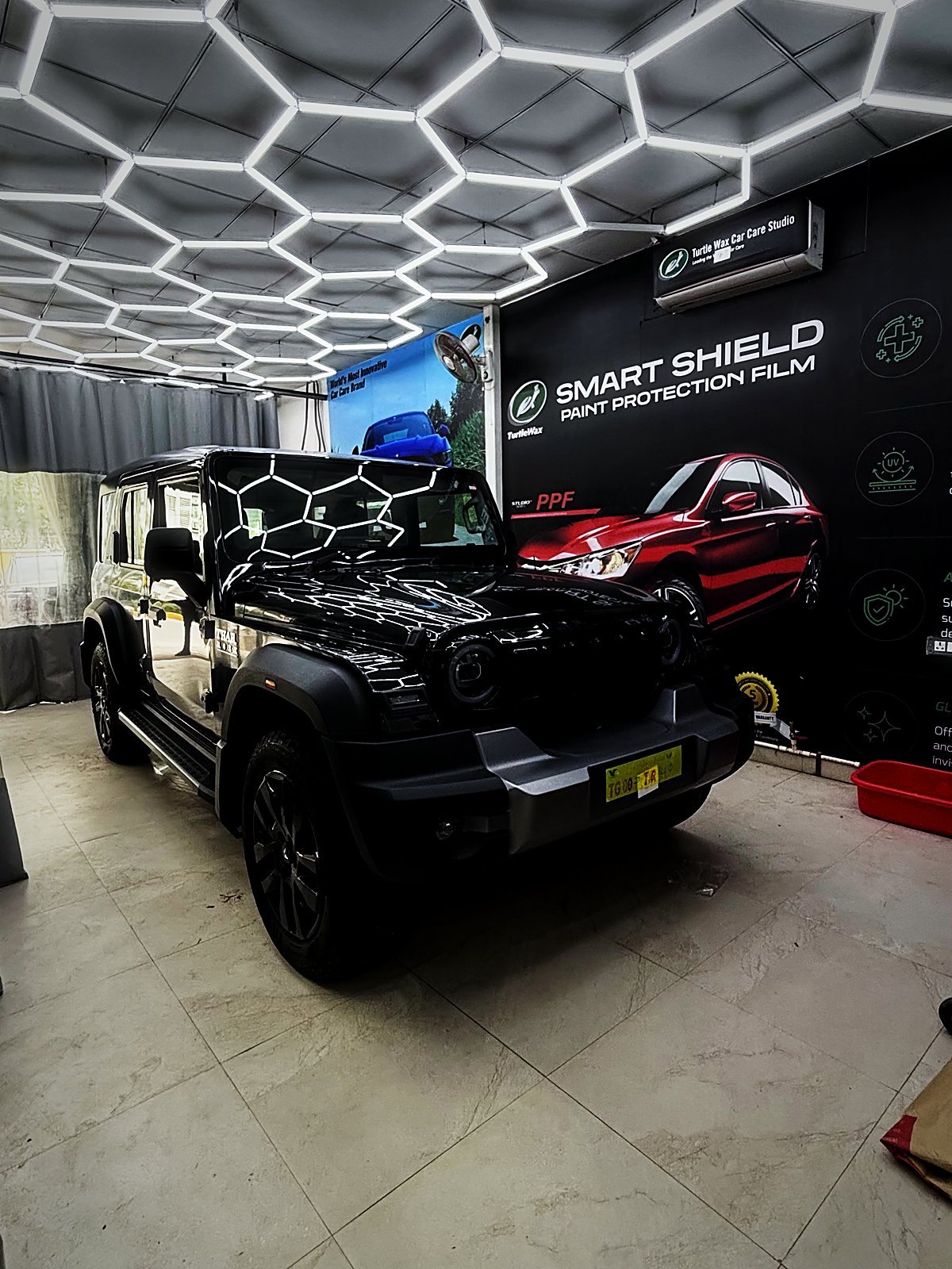 A vehicle in the Turtle Wax Studio Tellapur bay being fitted with accessories