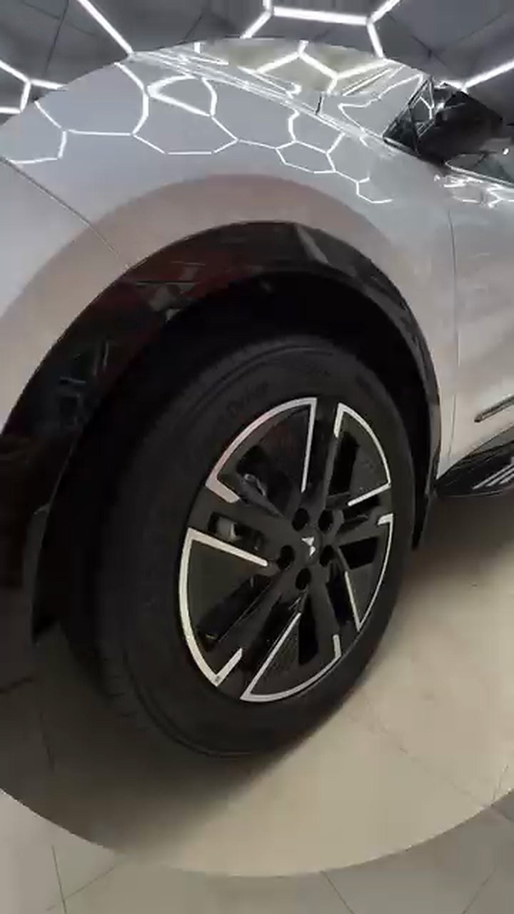 White Mahindra being machine polished at Turtle Wax Studio Tellapur